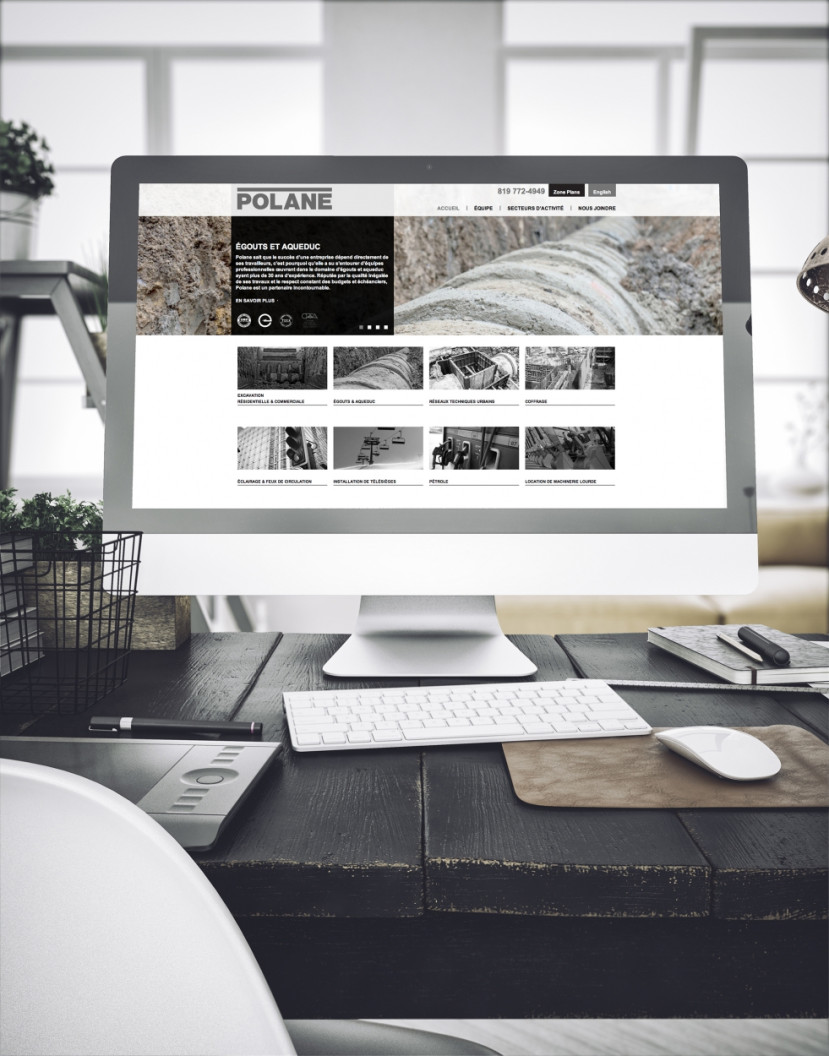 Écran d'ordinateur affichant le site web Polane avec images et texte sur un bureau moderne.